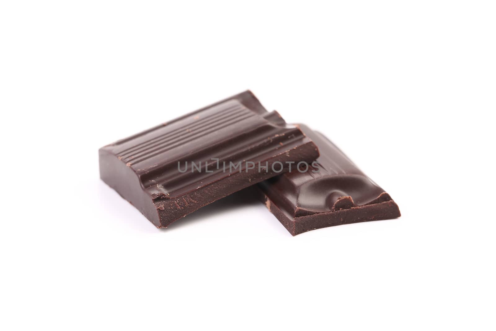 Tasty morsel of dark chocolate. Isolated on a white background.