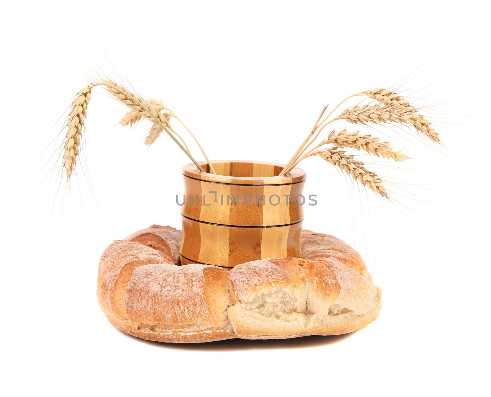 Wooden jar with ears into kalatch. Isolated on a white background.