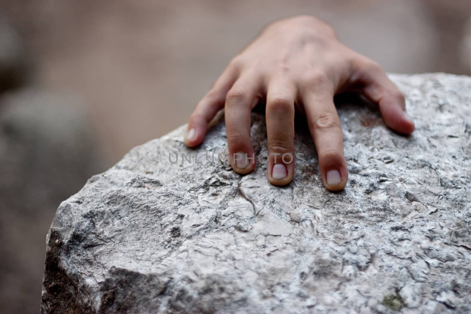 Hand holding a rock at the top