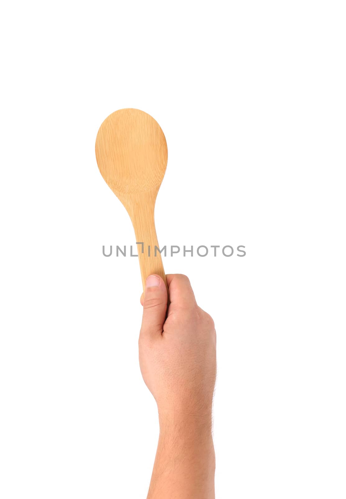 Hand holds wooden spoon. Isolated on a white background.