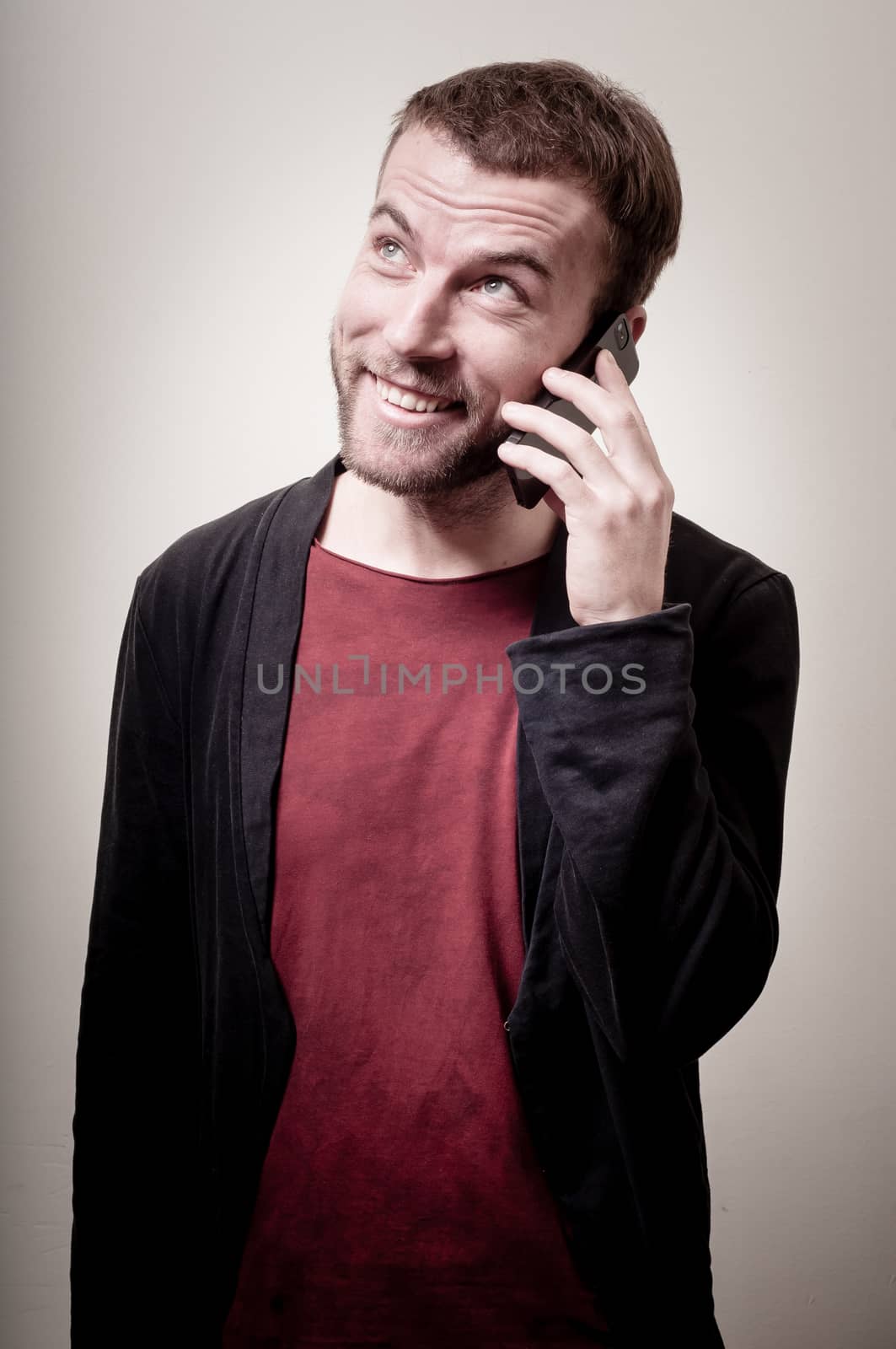 stylish hipster man on the phone on gray background