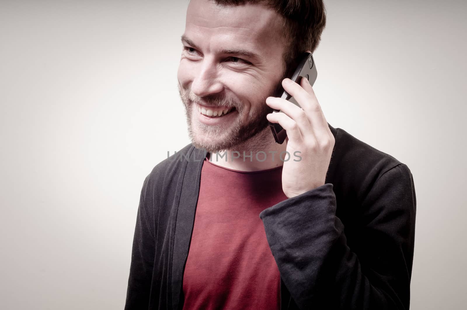 stylish hipster man on the phone on gray background