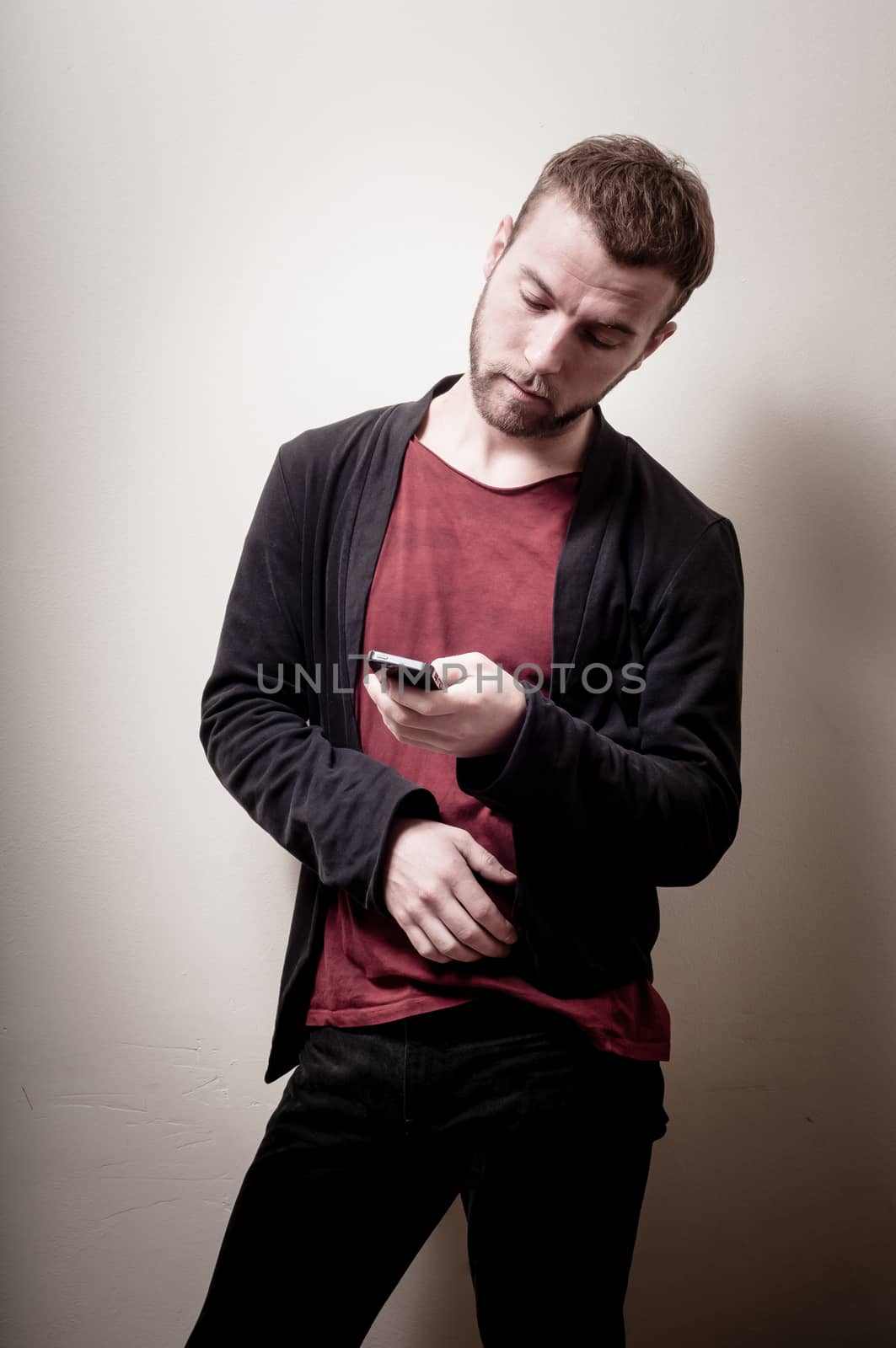 stylish hipster man on the phone on gray background