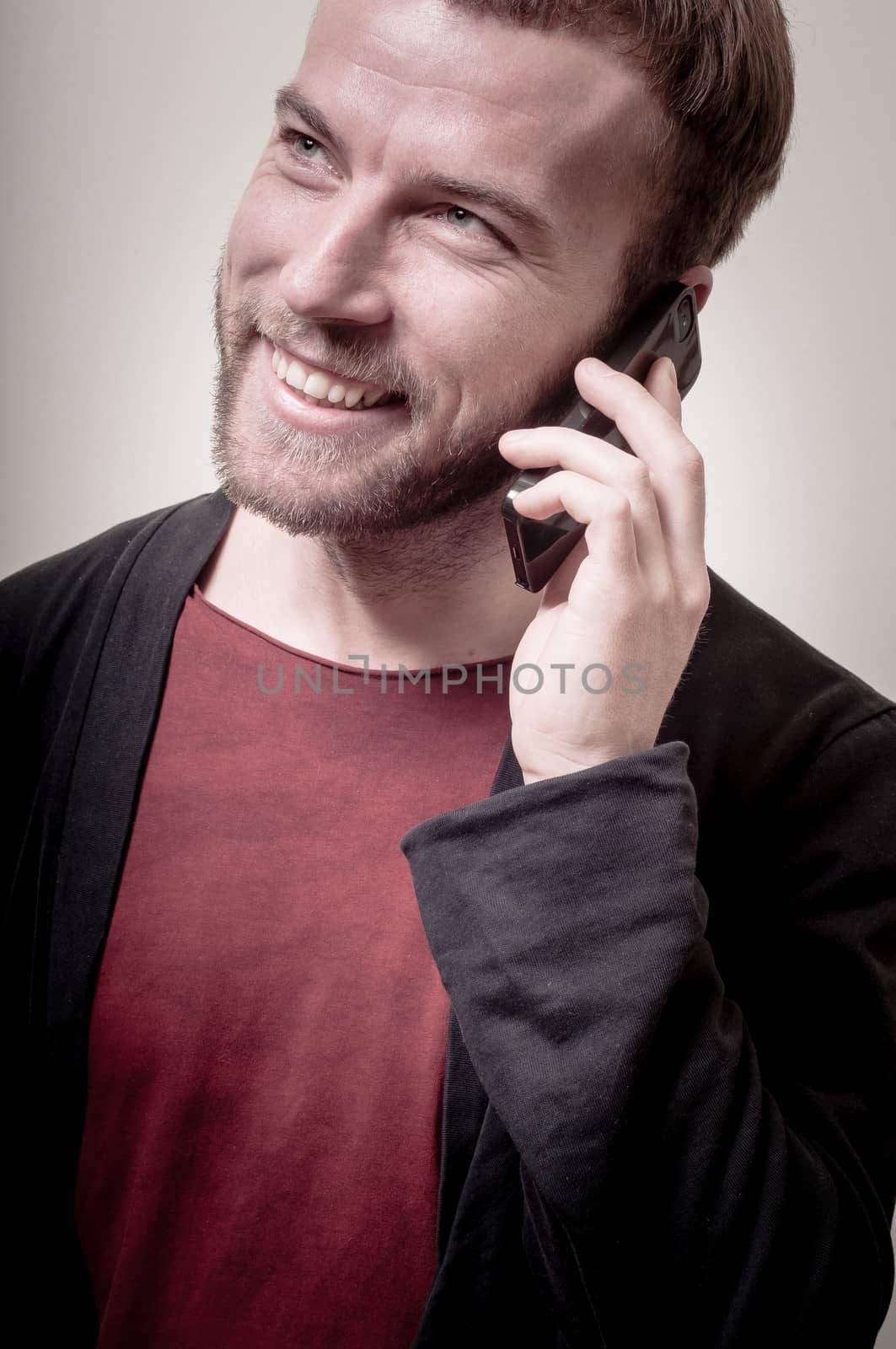 stylish hipster man on the phone on gray background
