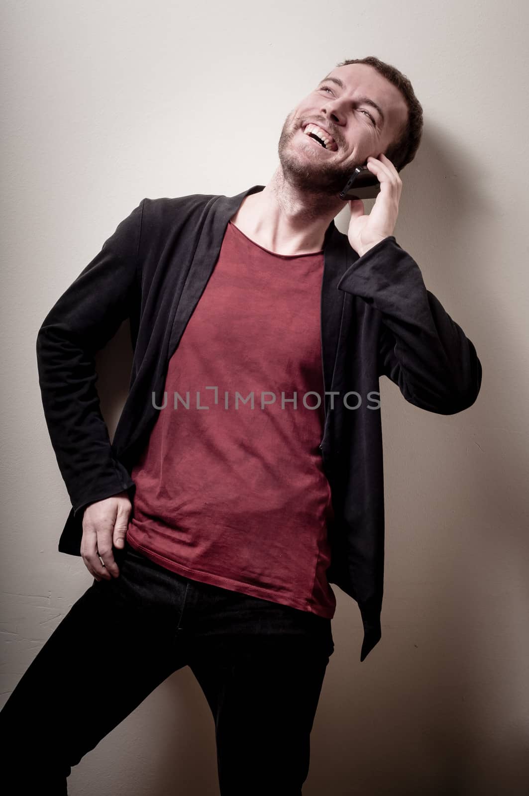 stylish hipster man on the phone on gray background