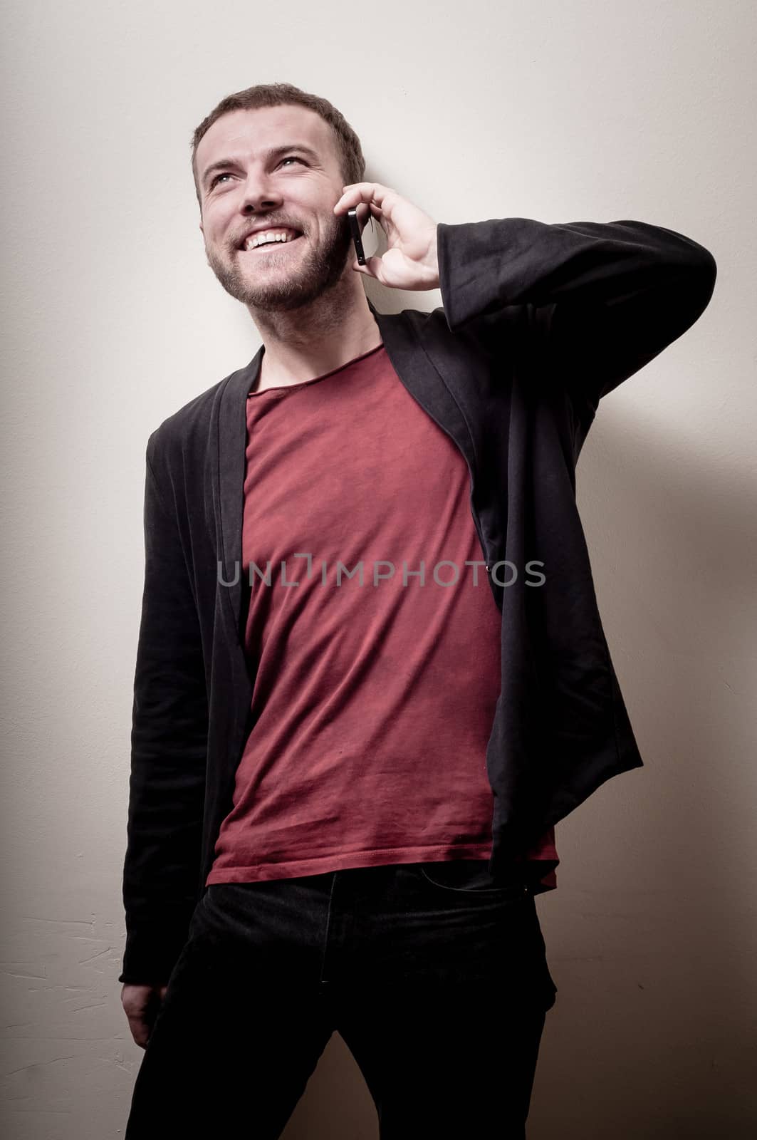 stylish hipster man on the phone on gray background