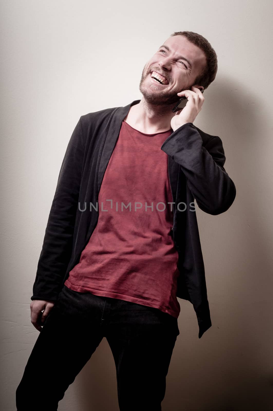 stylish hipster man on the phone on gray background