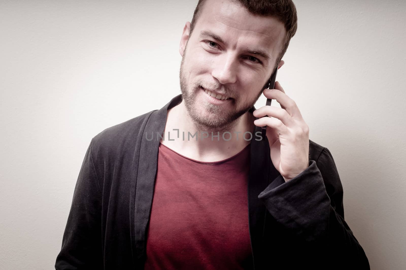 stylish hipster man on the phone on gray background
