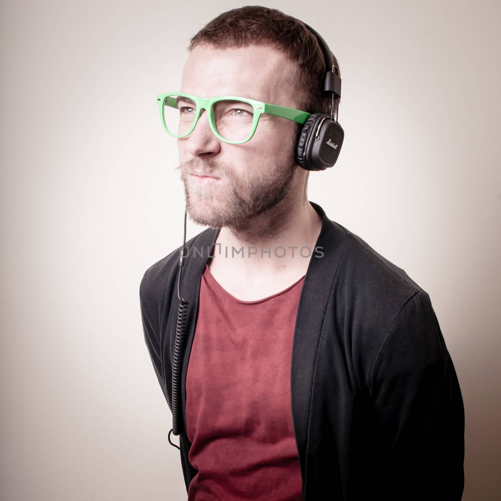 stylish hipster listening to music by peus