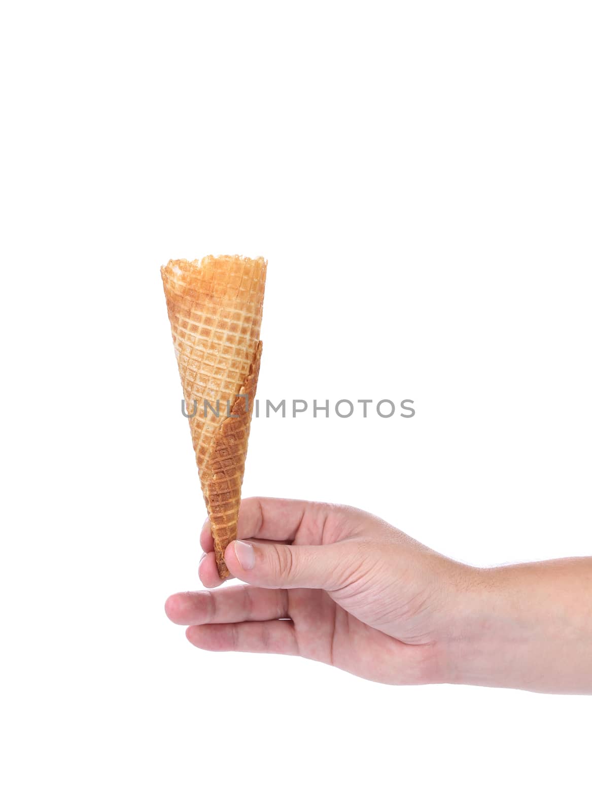 Hand holds empty sugar waffle cone isolated on white background