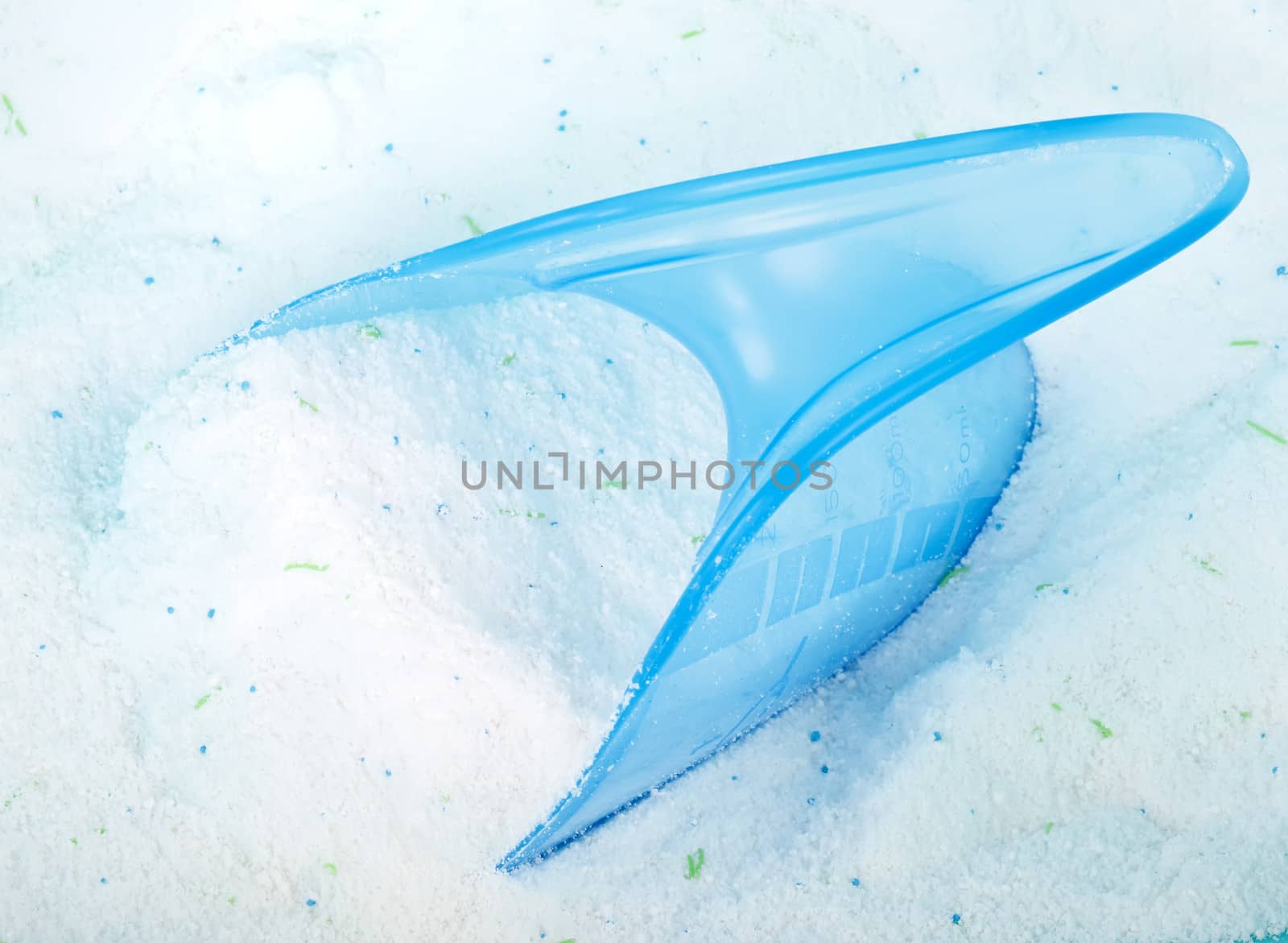 laundry detergent and blue plastic cup isolated on white background