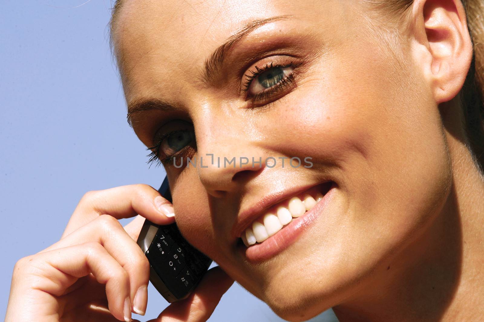 Beautiful woman talking on cell phone while looking at copyspace 