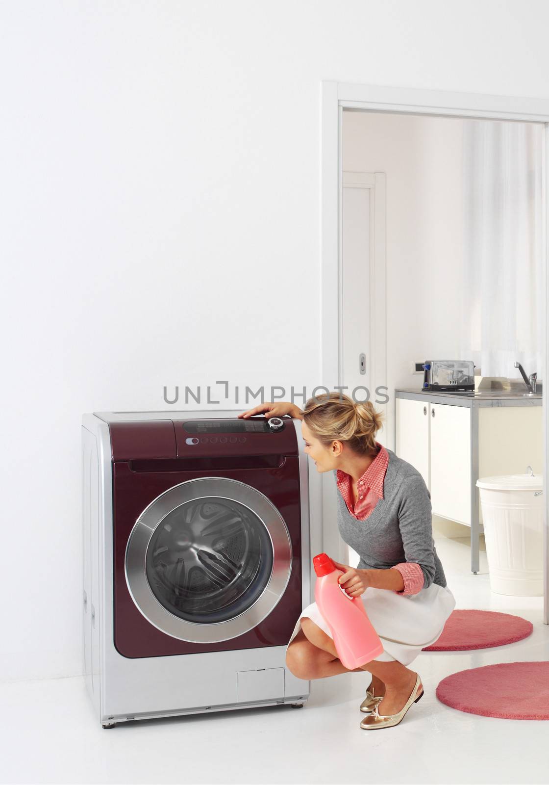 smiling woman dooing  laundry with washing machine 