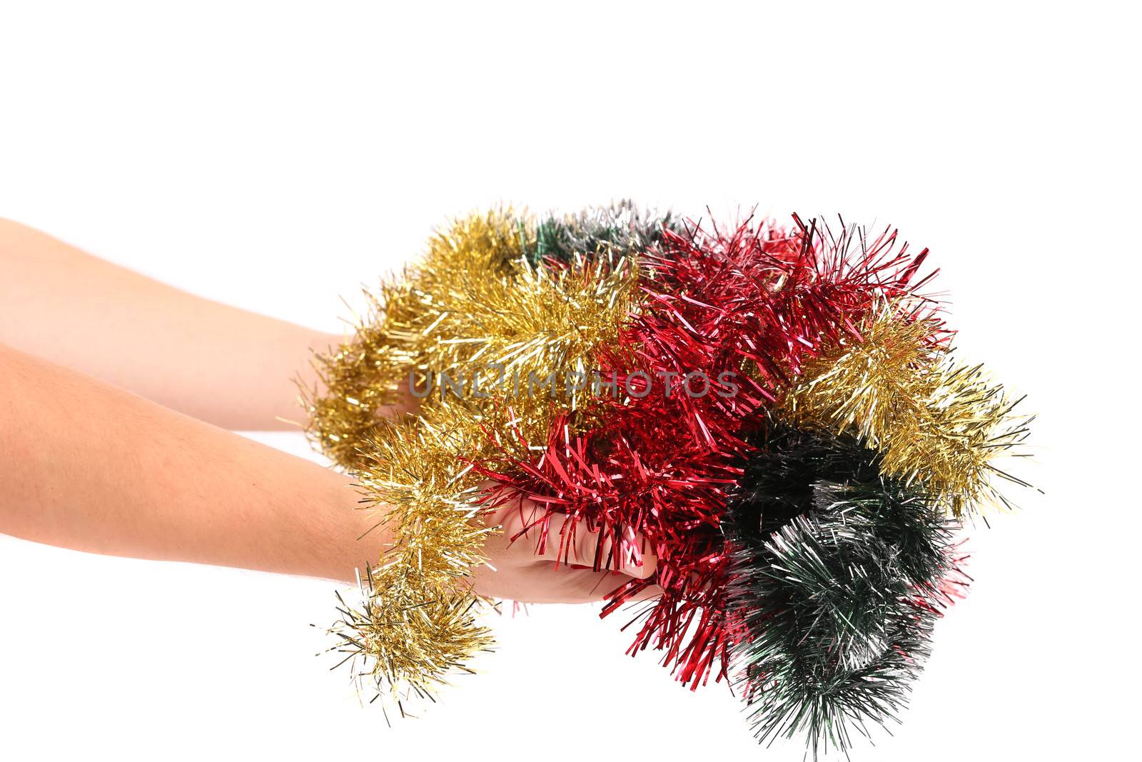 Different color tinsel on hand. Isolated on a white background.
