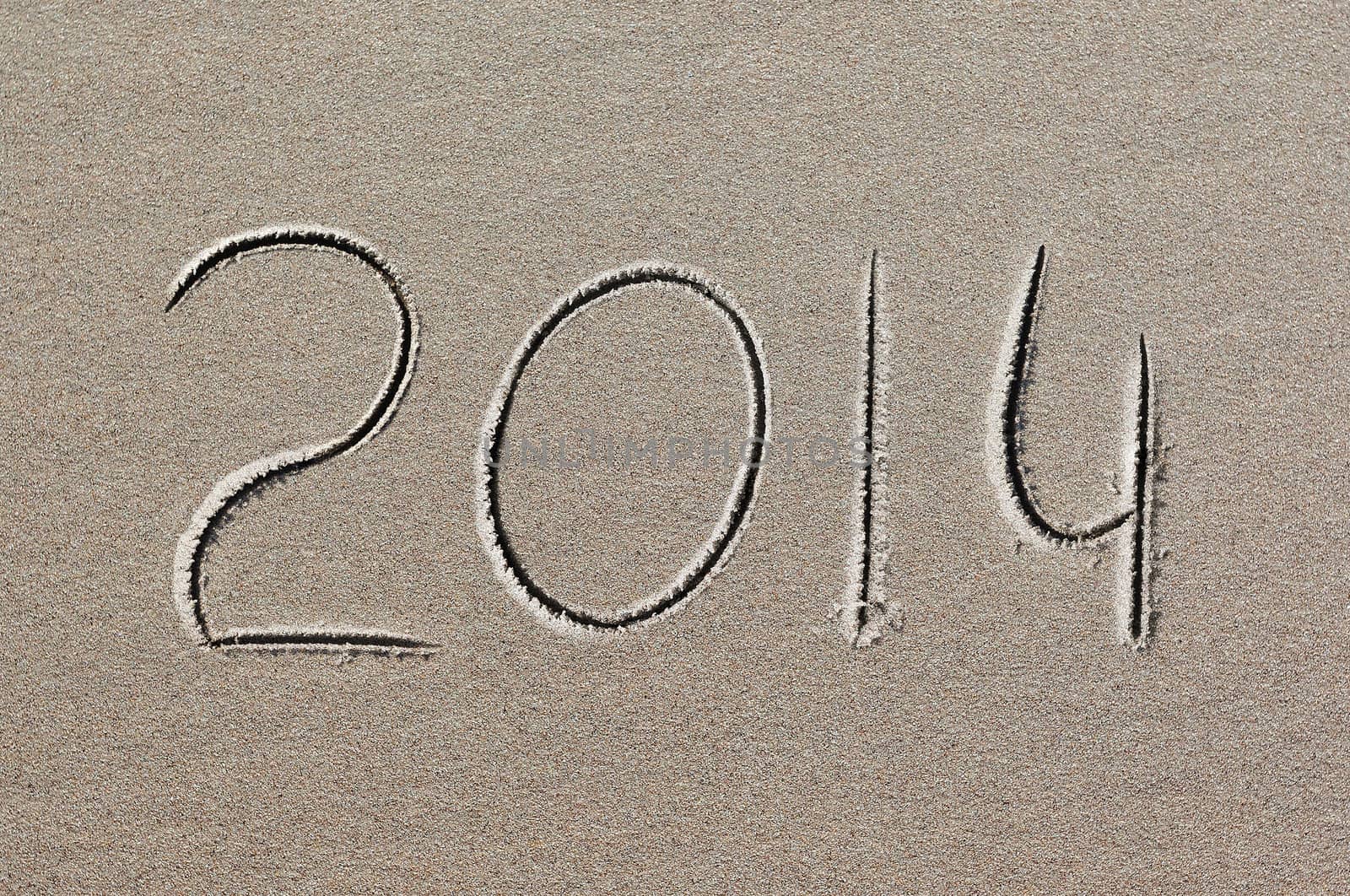 New Year background. 2014 written in sand