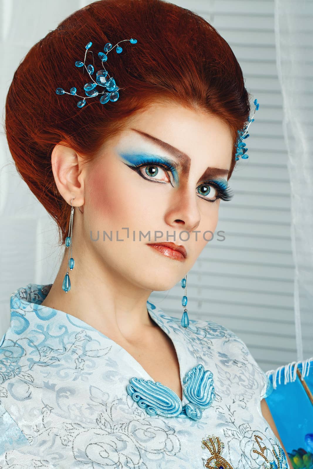 Portrait of attractive girl with make-up Geisha, shot close-up