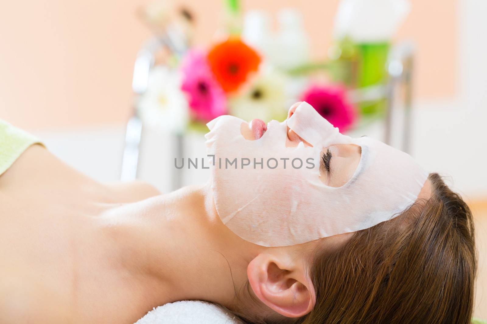 Wellness - woman getting face mask in spa by Kzenon