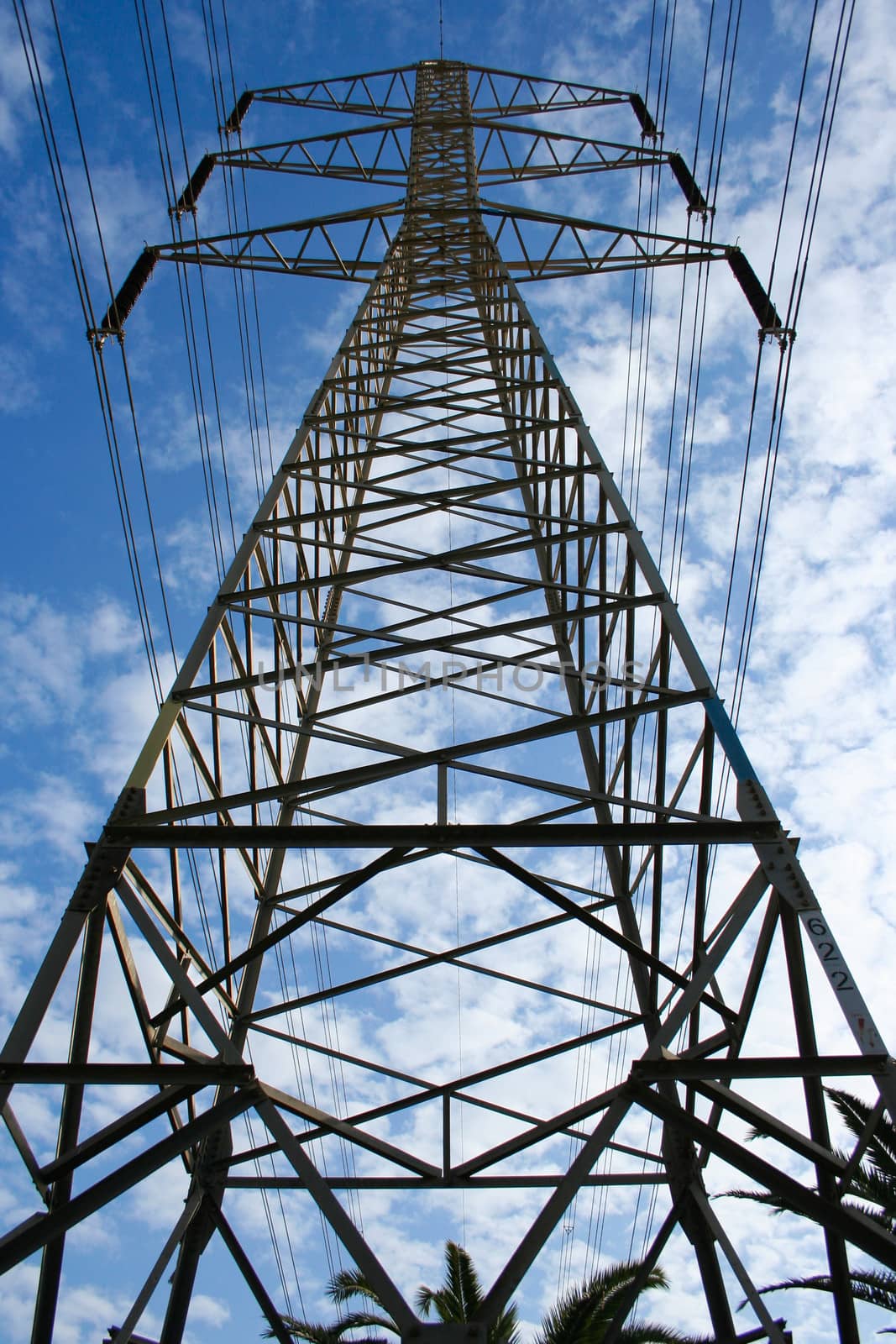 High voltage power lines on blue sky background