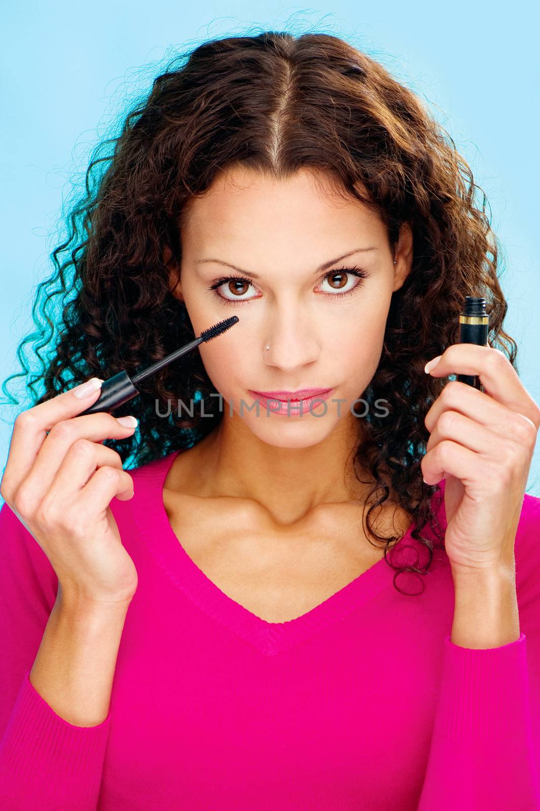 Pretty curl hair brunette woman holding mascara