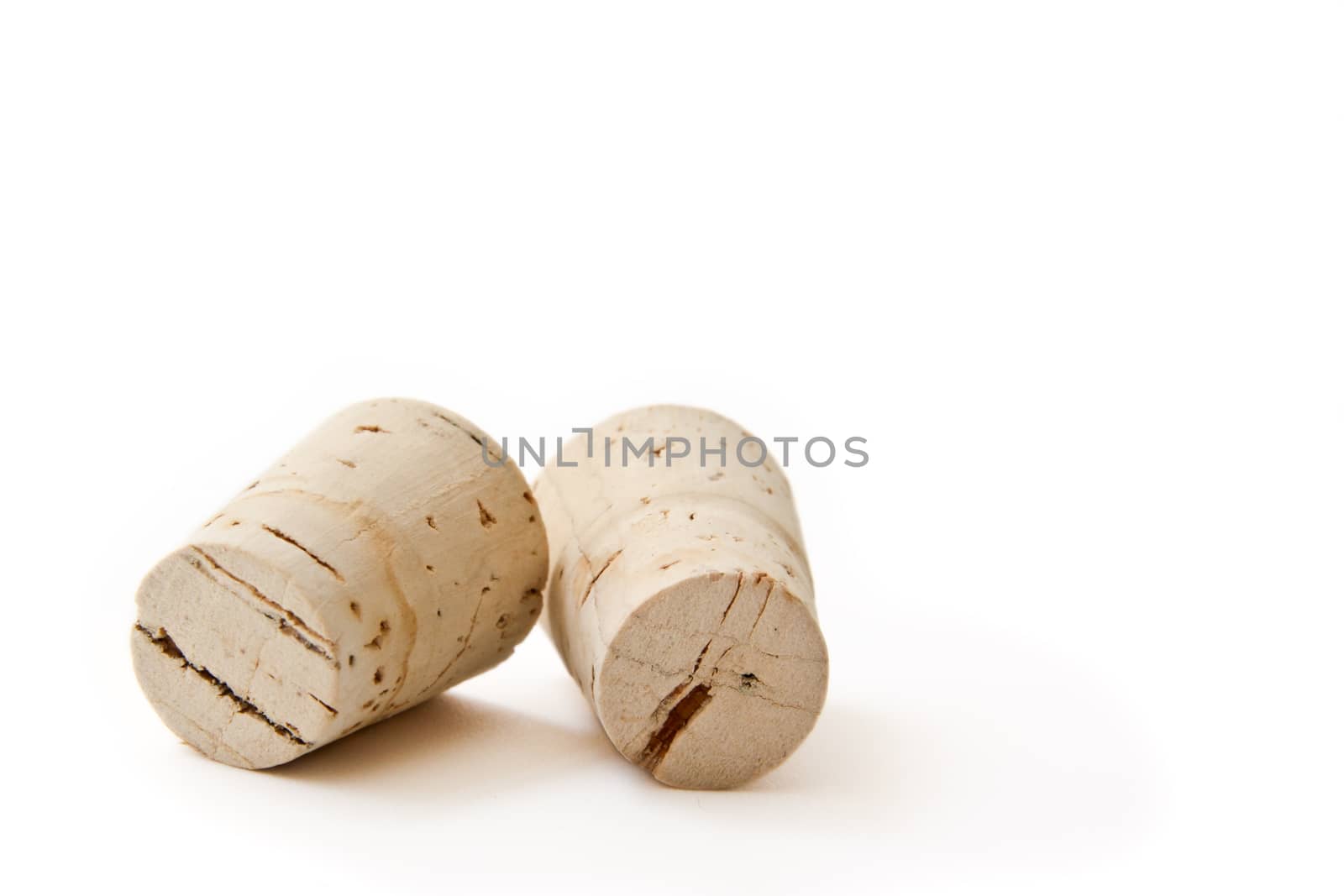 Two wine corks isolated on a white background