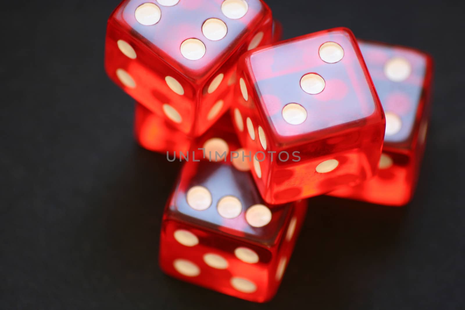 Red dice on black background