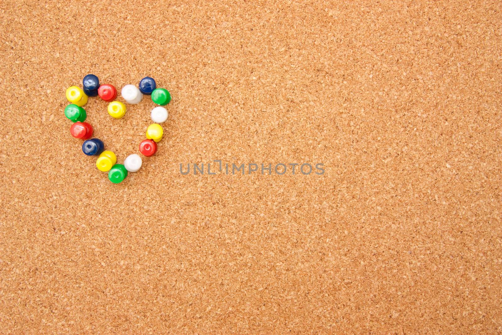 Corkboard with pushpins as heart