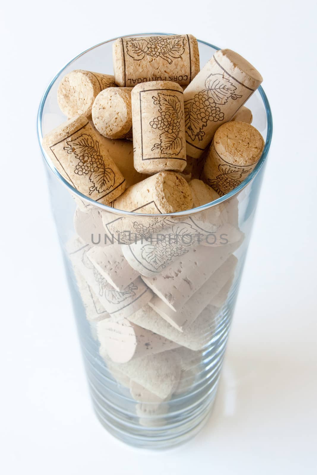 Wine cork in a glass on white background