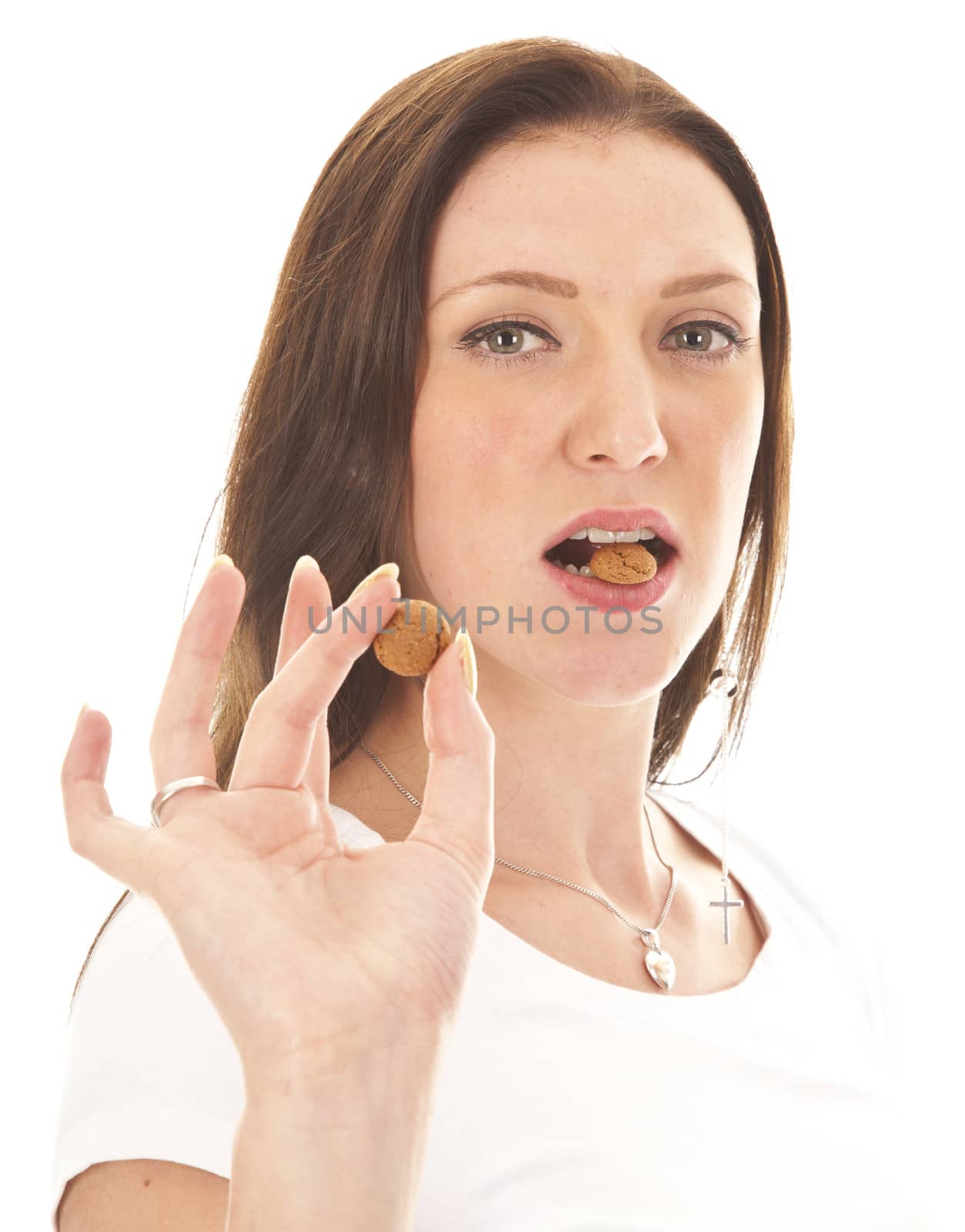 Young woman holding typical Dutch candy pepernoten isolated on white background