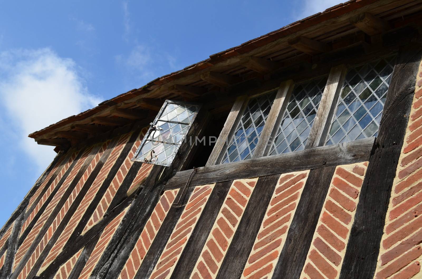 Leaded light windows on a ancient Medieval building.