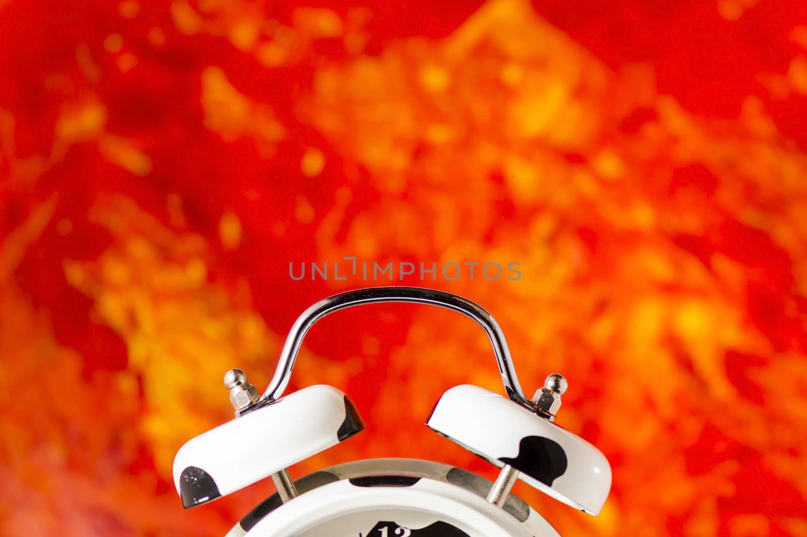 Detail of a white alarm clock on colored background