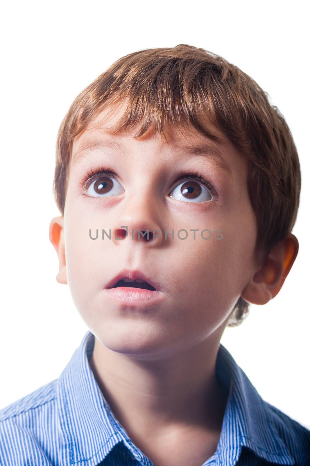 Boy with astonished expression on white background