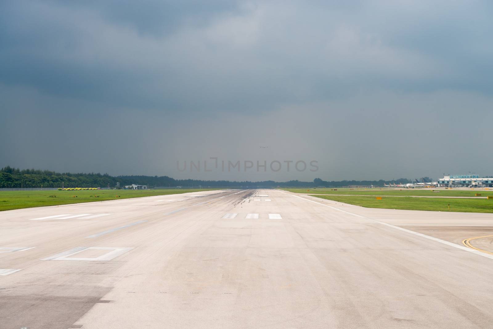 Airport runway under storm sky by iryna_rasko