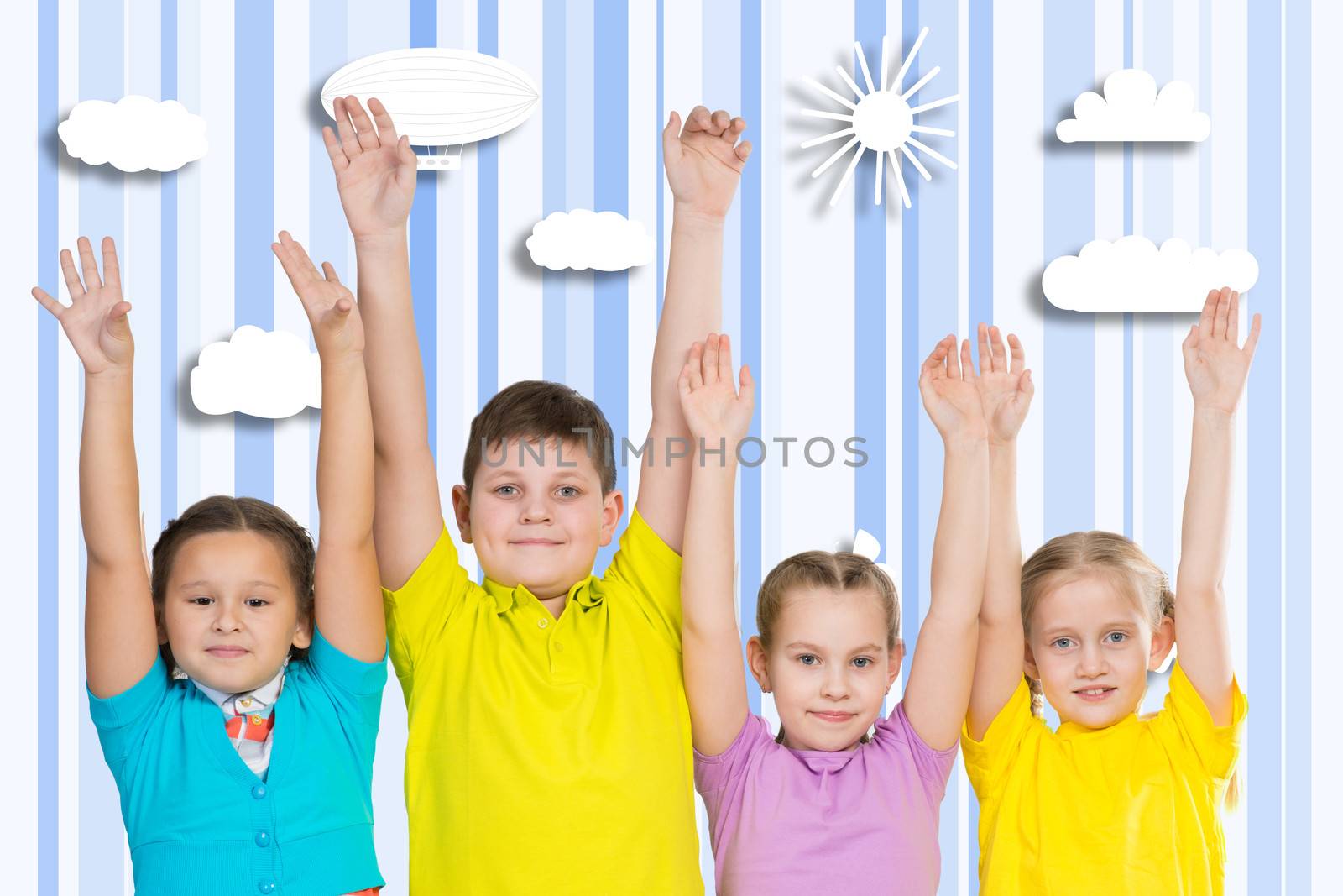 children in a row, hands up. behind painted background
