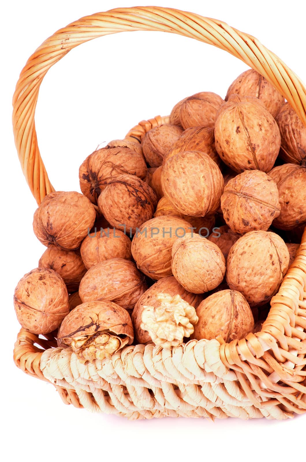 Wicker Basket with Ripe Walnuts closeup on white background