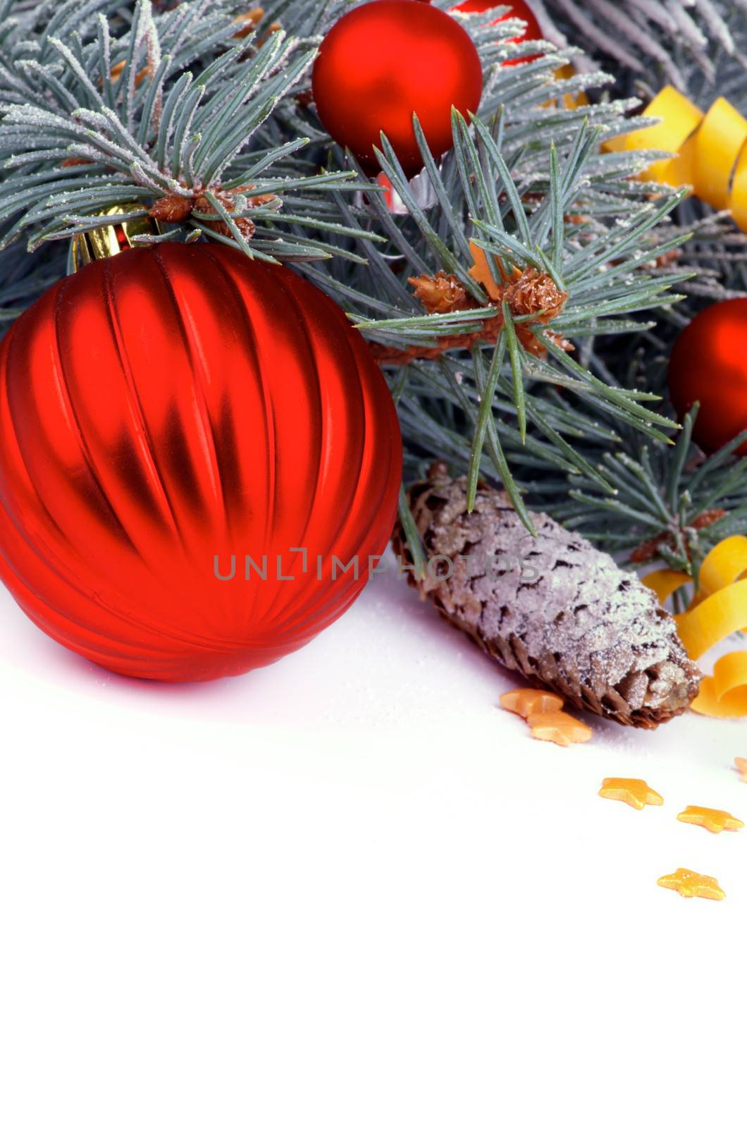 Christmas Theme. Frame of Spruce Branch with Hoar-Frost, Red Balls and Golden Stars closeup on white background