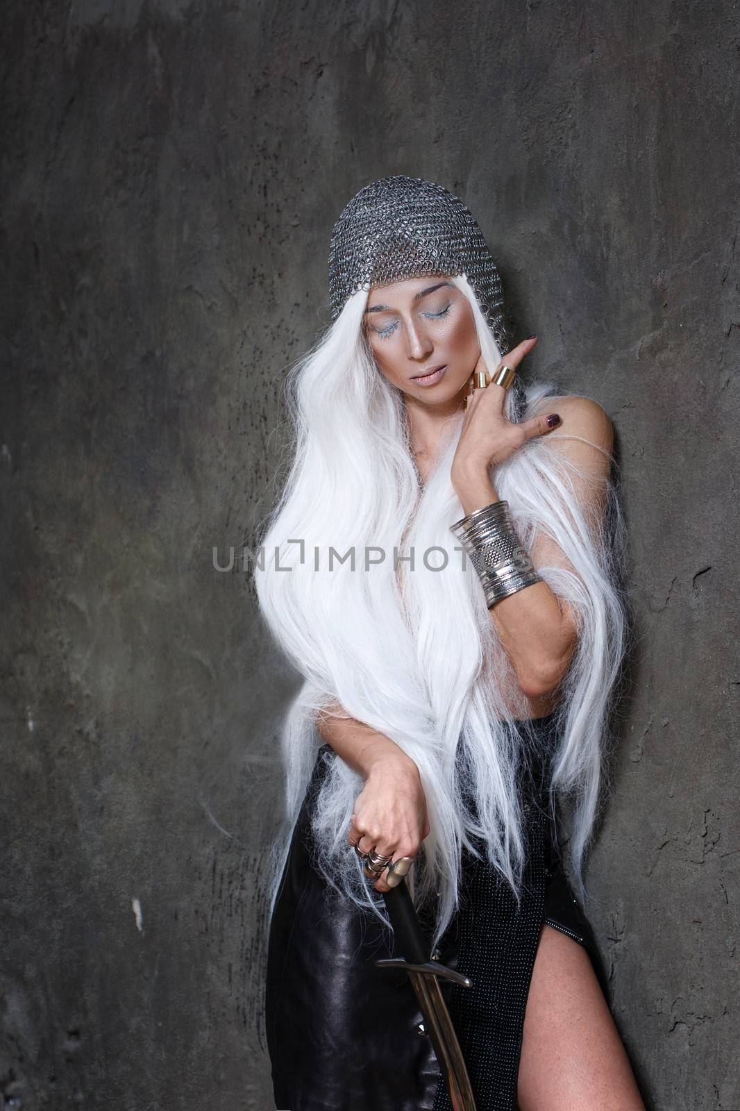 Girl with long white hair in chain mail and sword