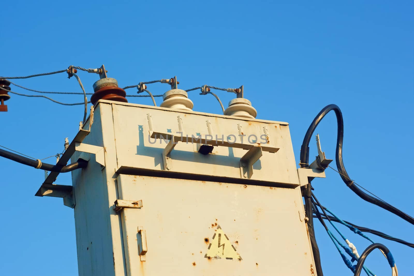 Old transformer against blue sky by qiiip