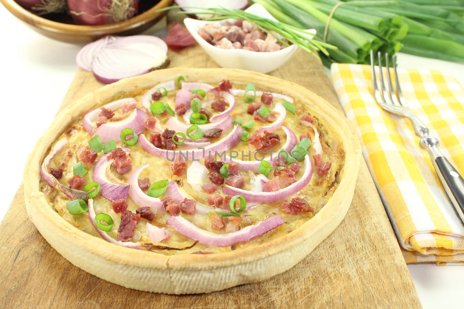 Onion tart with bacon on a light background