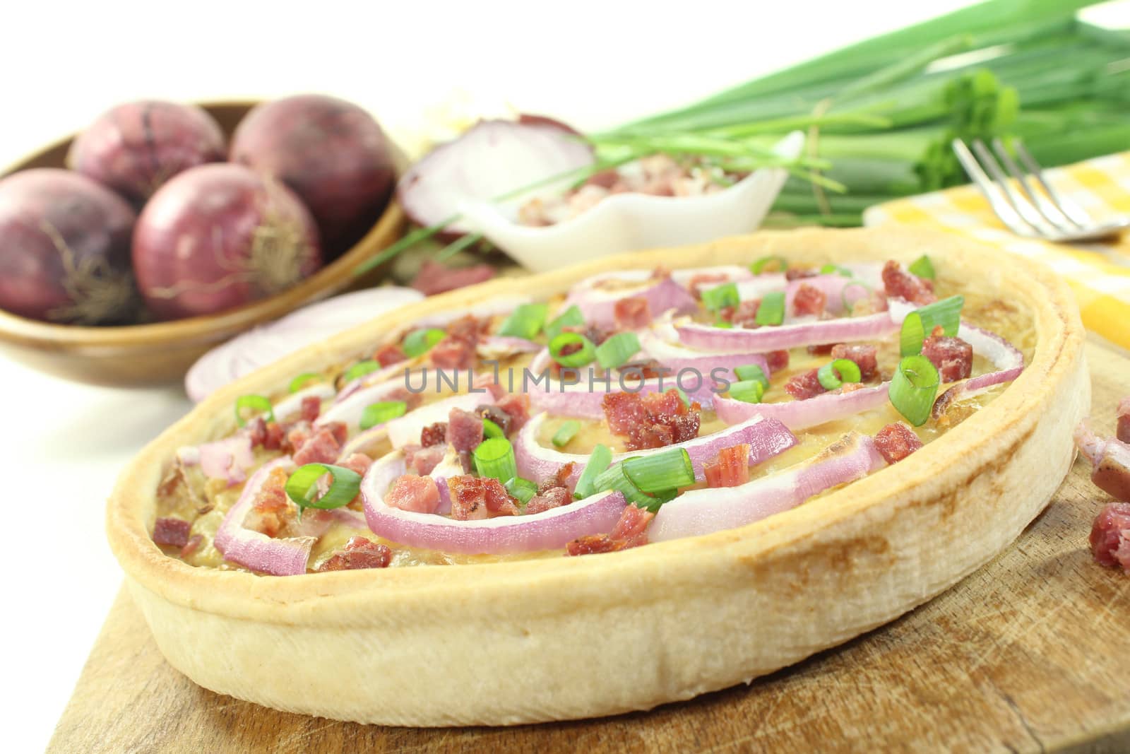 Onion tart with leeks on a light background