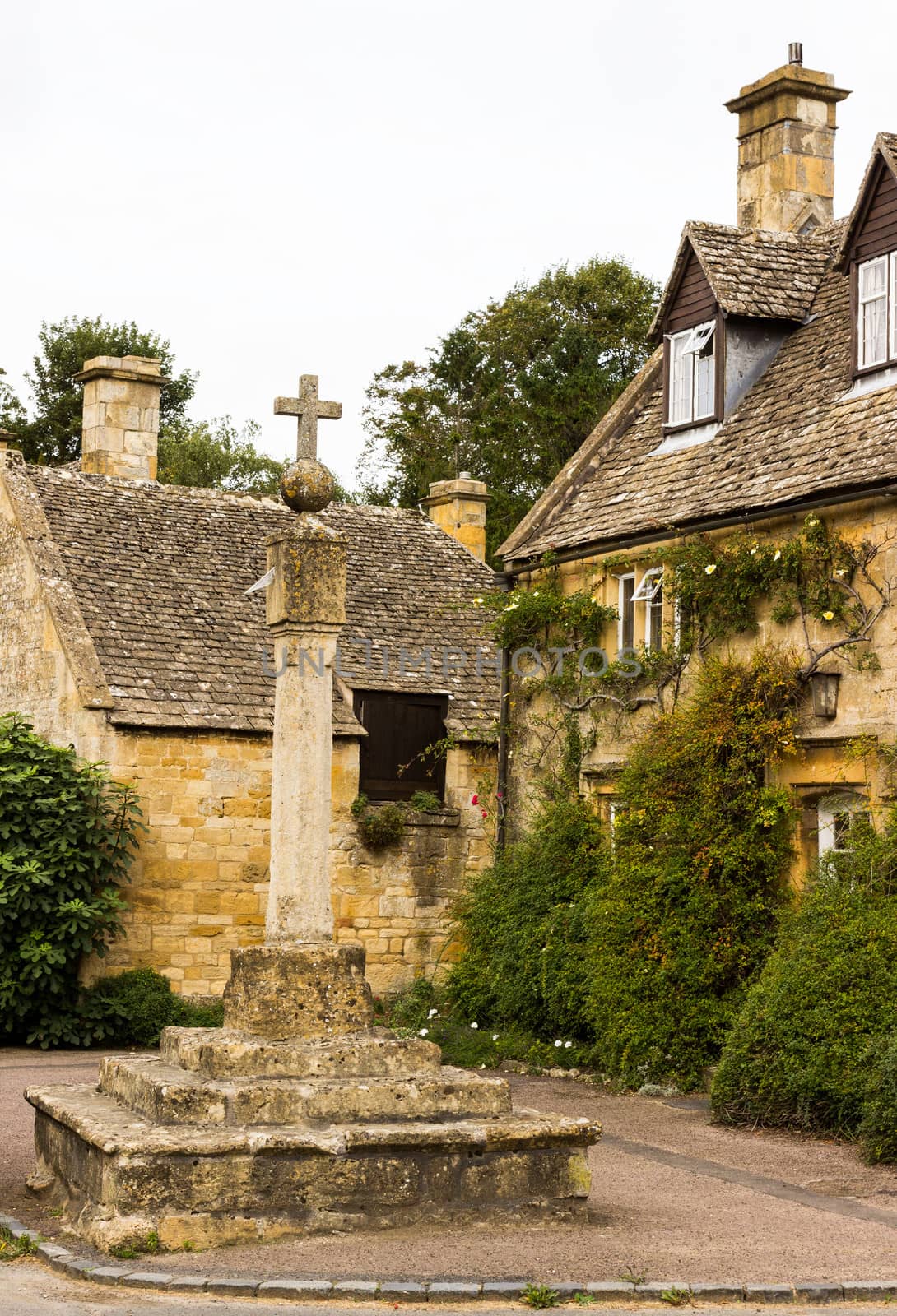 Town square with cross in Stanton in Cotswold or Cotswolds district of southern England in the autumn.