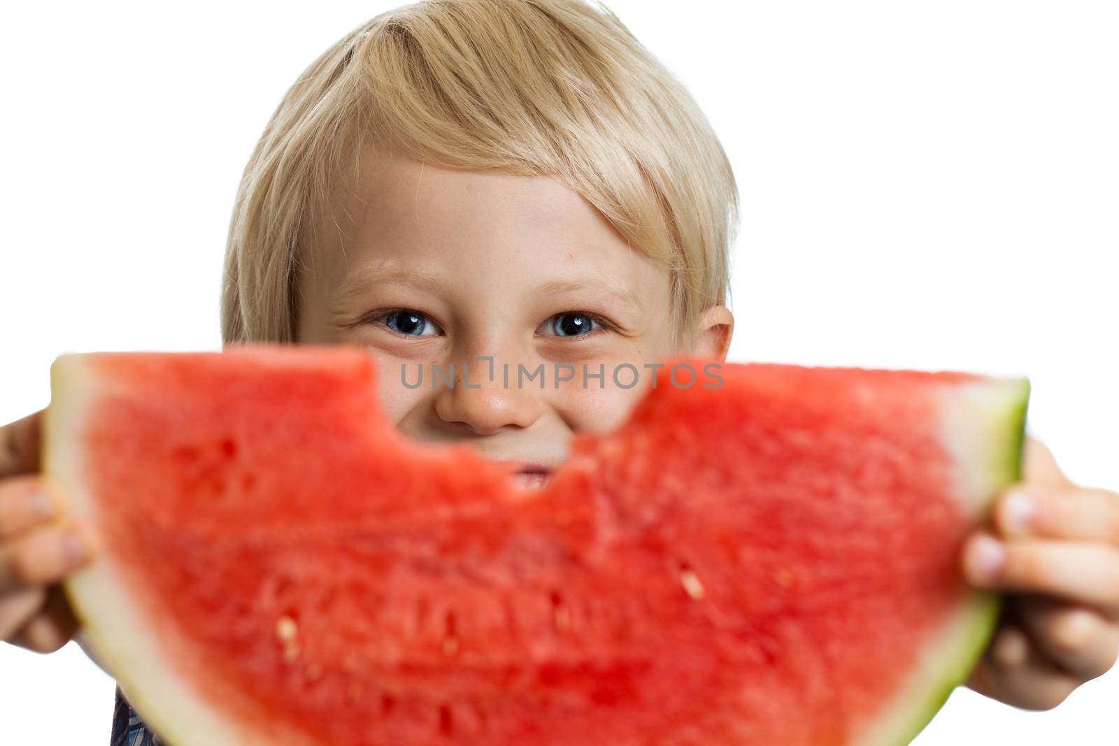 A cute happy boy holding a big juicy slice of watermelon. Isolated on white.