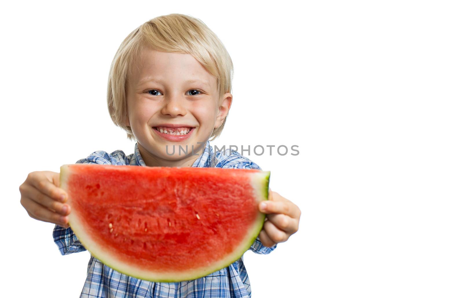 A smiling boy holding out a big juicy slice of watermelon. Isolated on white.