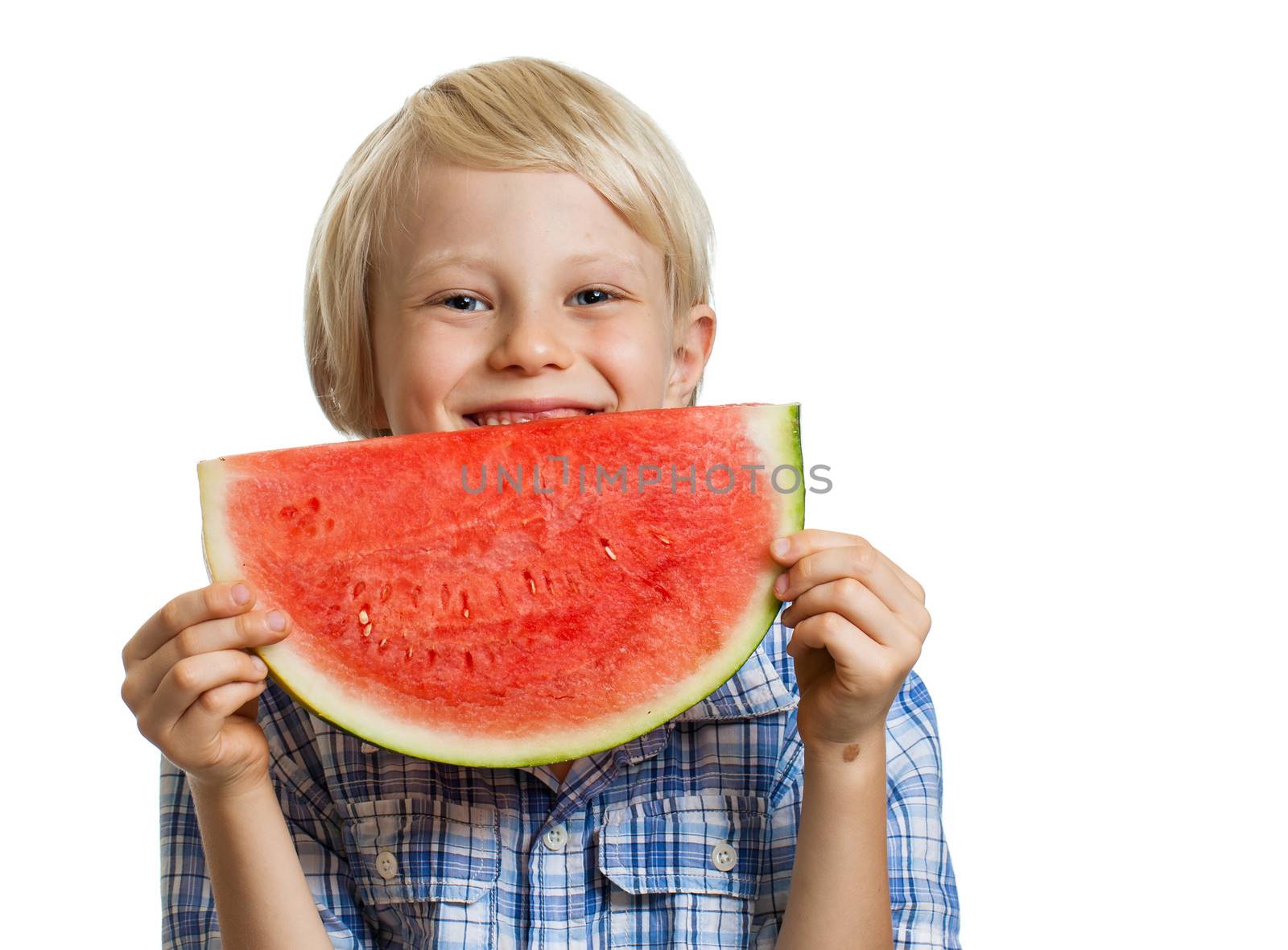 A cute happy boy smiling behind a juicy  slice of watermelon. Isolated on white.