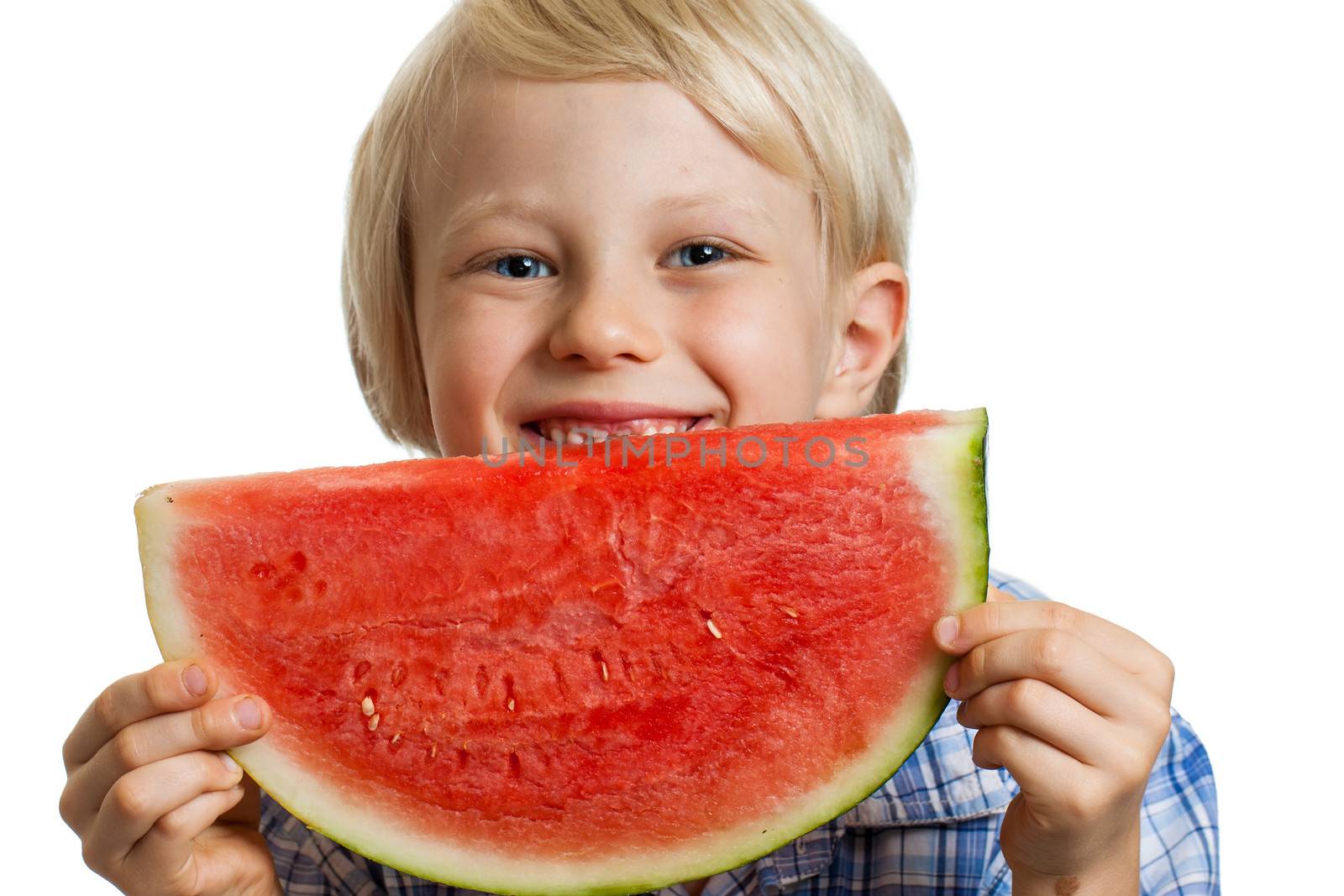 Close-up shot of a cute happy  boy smiling behind a juicy  slice of watermelon. Isolated on white.