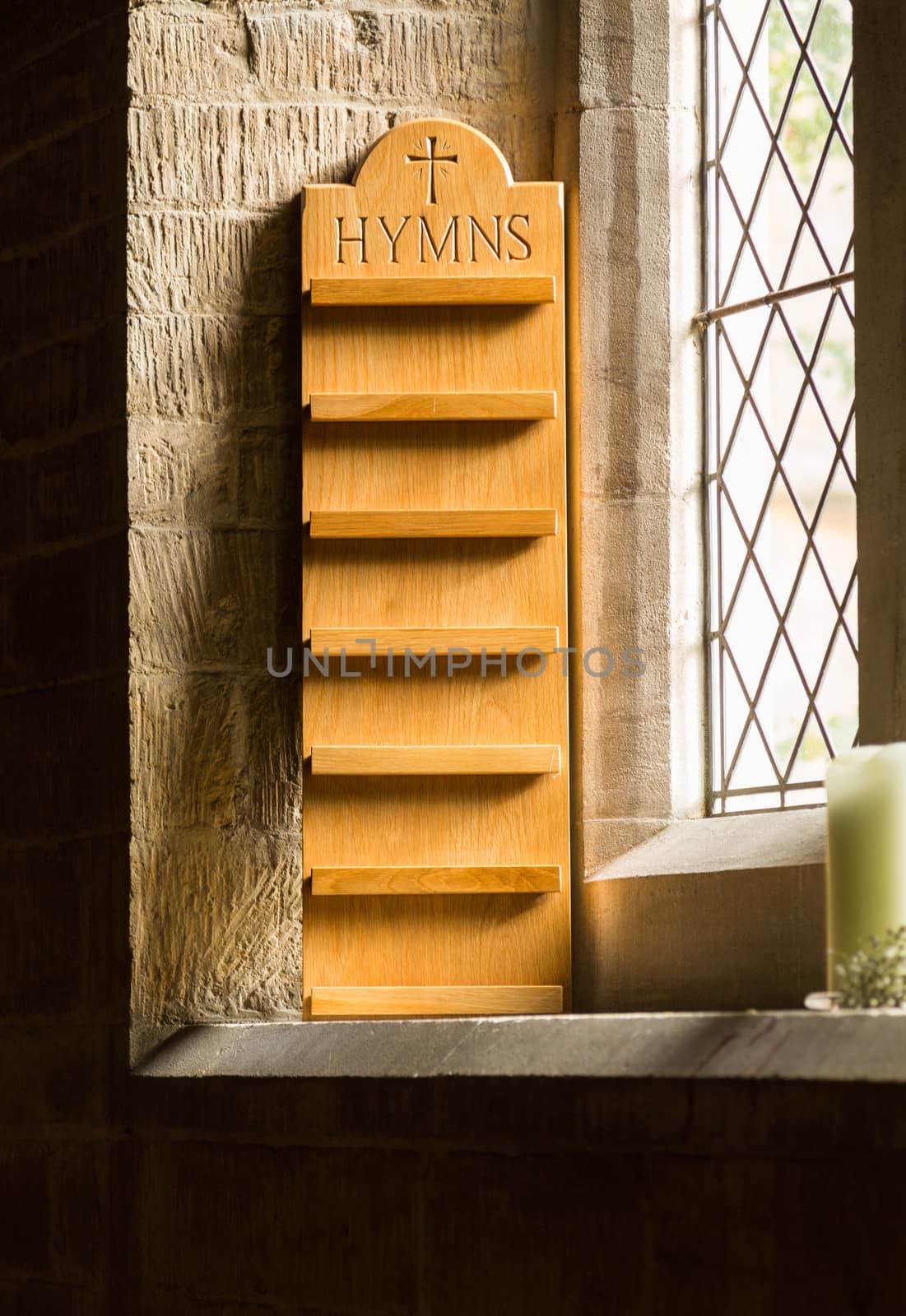 Empty hymn stand in window of old parish church in Cotswold or Cotswolds district of southern England