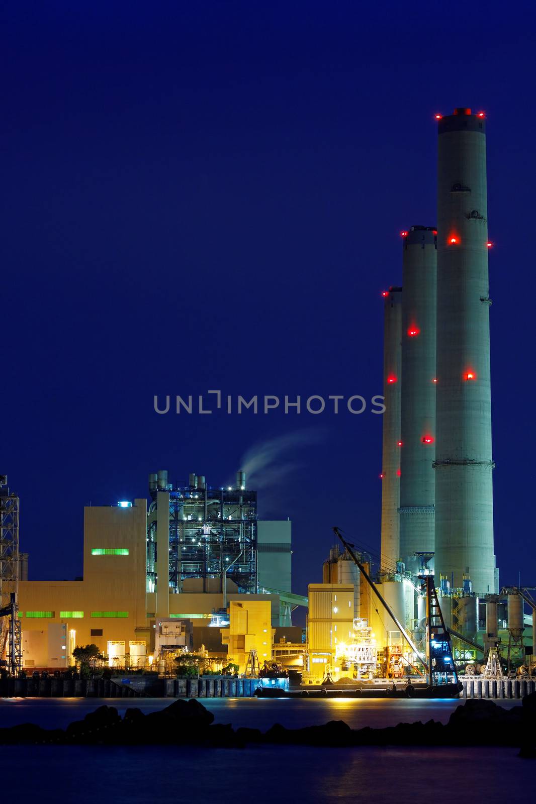 power station at night with smoke 