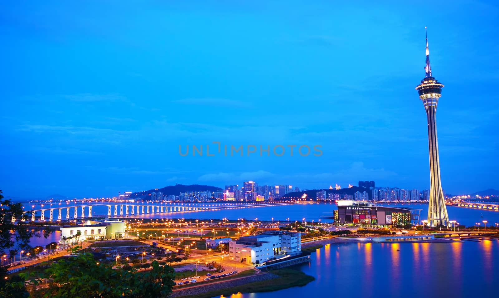 Urban landscape of Macau with famous traveling tower under blue sky near river in Macao, Asia. 