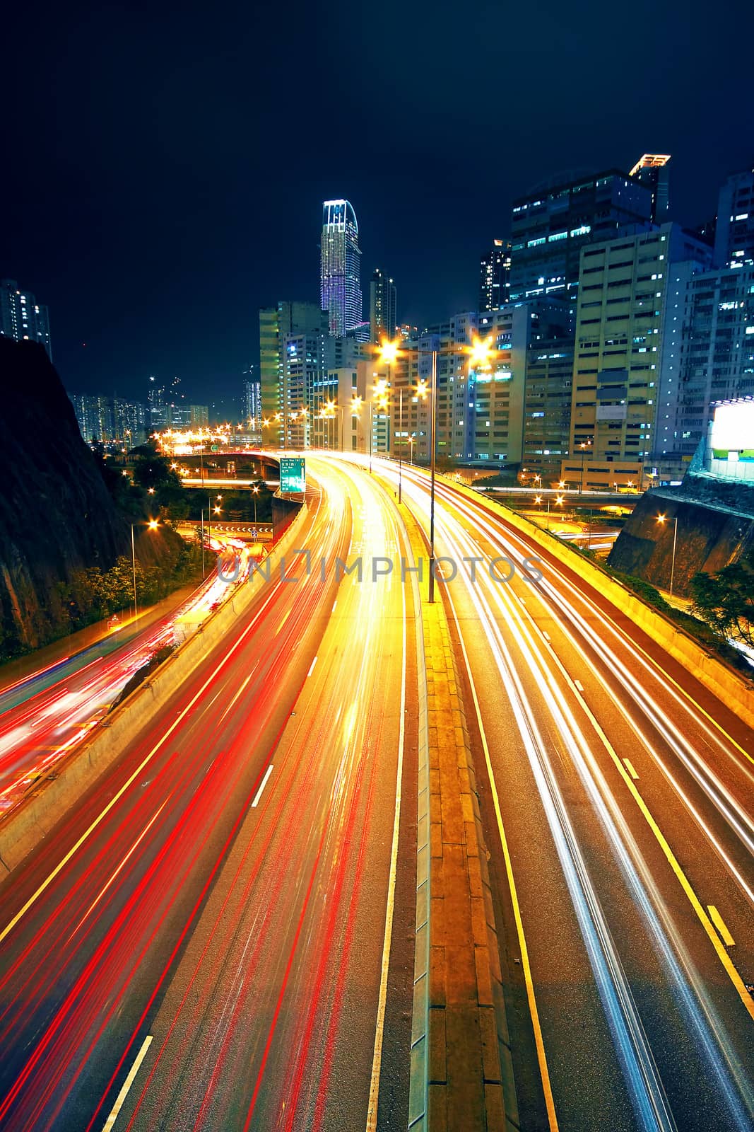 Night traffic on a busy city highway by cozyta