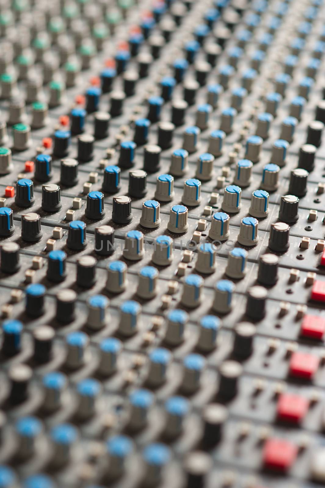 Detail of a music mixer in studio, closeup. by stockyimages
