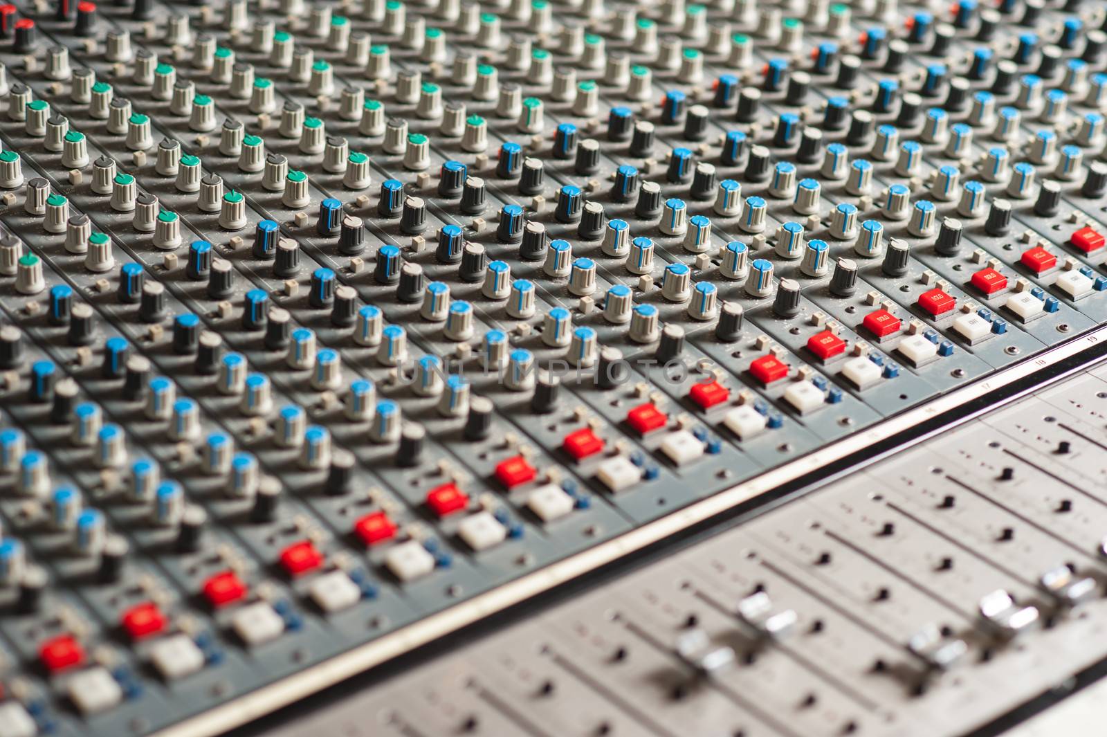 Audio mixing console, closeup shot. by stockyimages